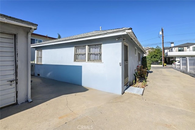 view of side of home with a patio area