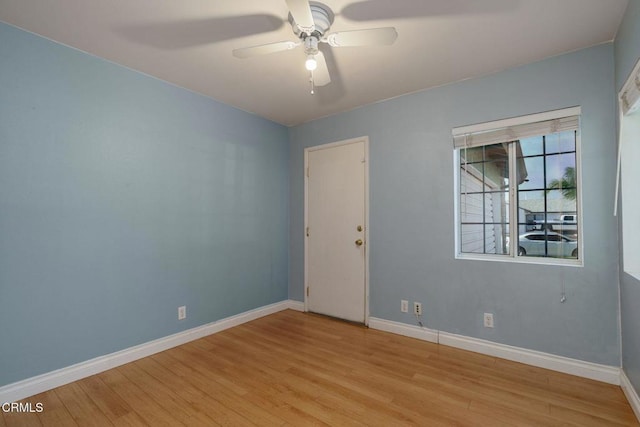 empty room with ceiling fan and light hardwood / wood-style flooring