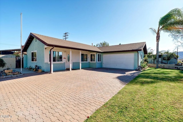 ranch-style home featuring a front lawn and a garage