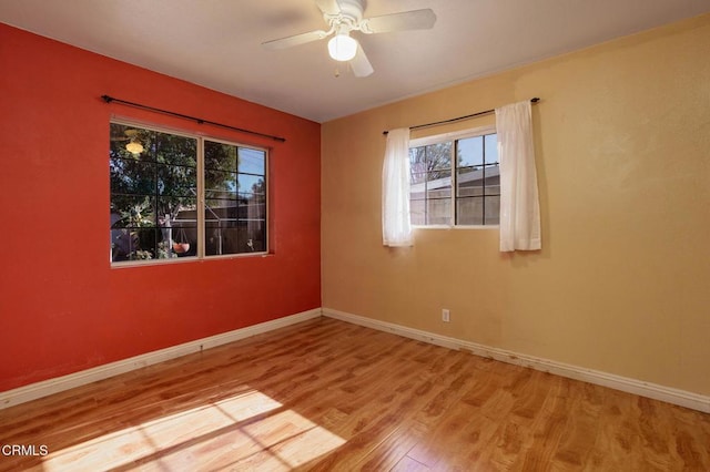 spare room with ceiling fan and hardwood / wood-style floors