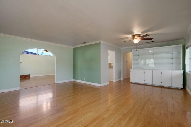 unfurnished living room with light hardwood / wood-style flooring, ceiling fan, and crown molding