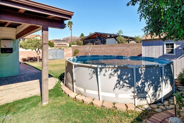 view of pool featuring a yard