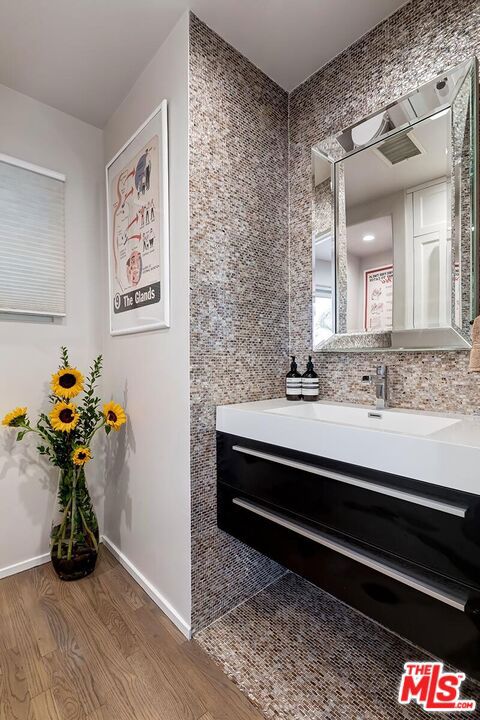 bathroom featuring hardwood / wood-style floors and vanity