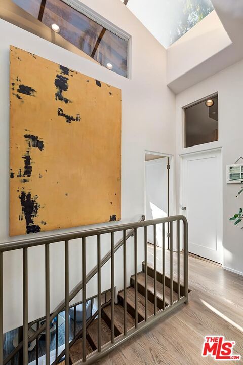 staircase featuring hardwood / wood-style floors and a towering ceiling