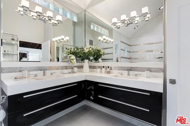 bathroom with tile patterned flooring, vanity, and tasteful backsplash