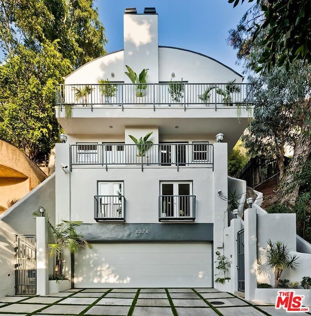 view of front of home featuring a balcony and a garage