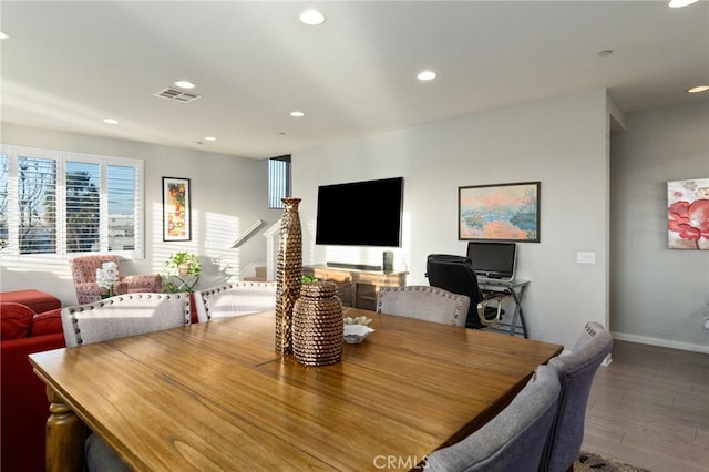 dining area featuring baseboards, wood finished floors, visible vents, and recessed lighting