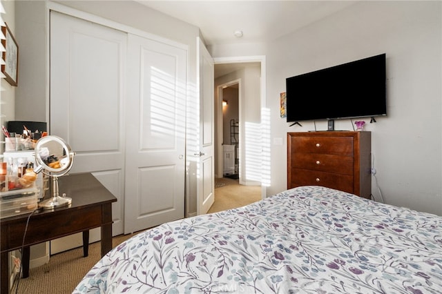 bedroom featuring light carpet and a closet