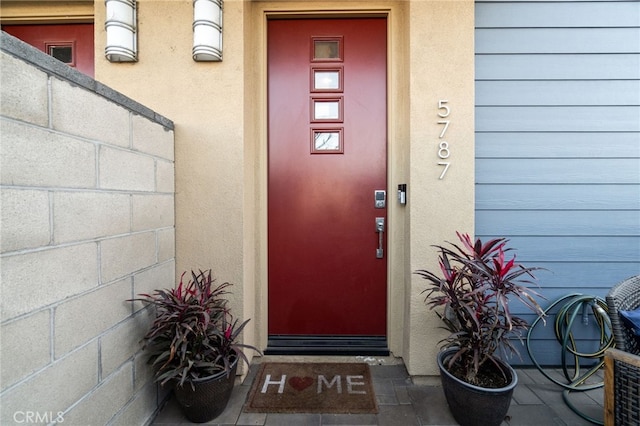 entrance to property with stucco siding