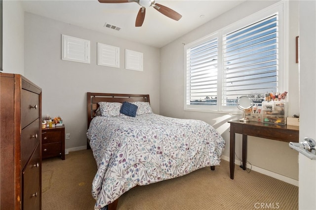 bedroom featuring visible vents, ceiling fan, light carpet, and baseboards