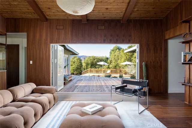 entryway with dark hardwood / wood-style floors, wood walls, wooden ceiling, and beam ceiling