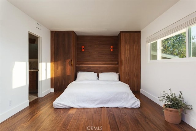 bedroom featuring dark hardwood / wood-style floors