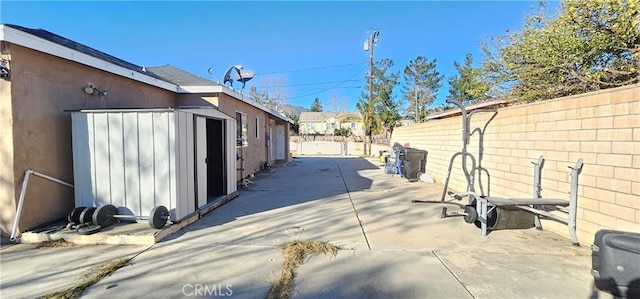 view of side of home featuring a shed