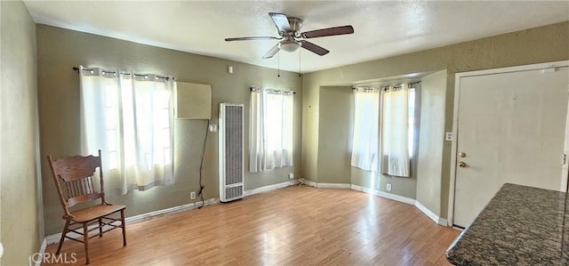 foyer entrance with ceiling fan and light hardwood / wood-style floors