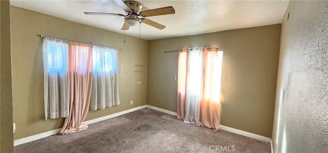 empty room with ceiling fan and carpet flooring