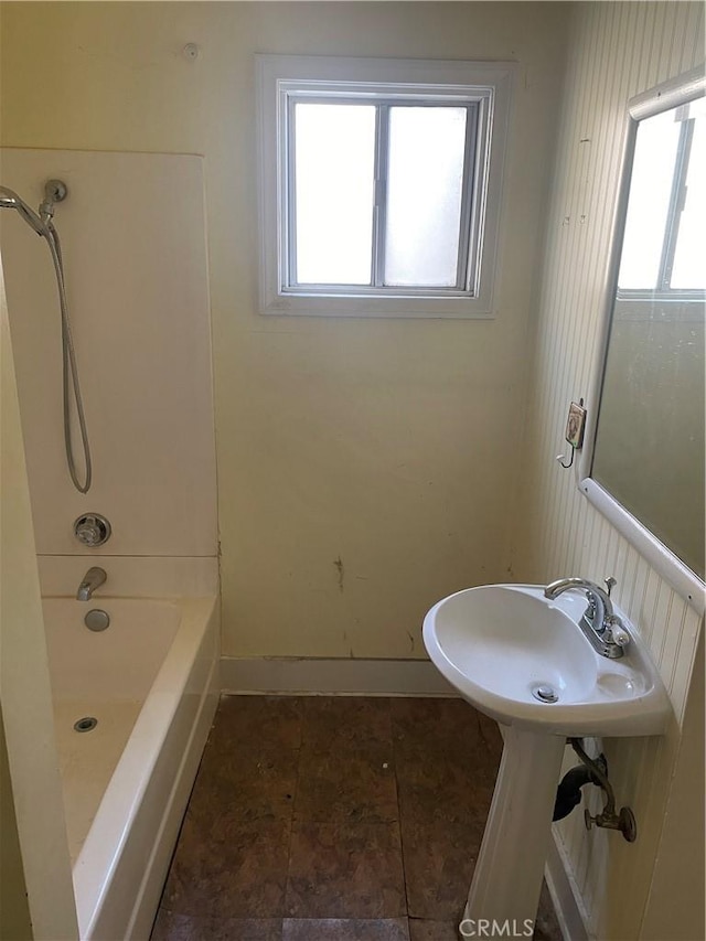 bathroom with bathtub / shower combination and plenty of natural light