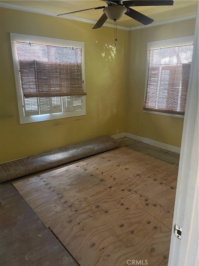 spare room with ceiling fan and crown molding