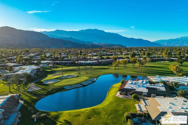 birds eye view of property with a water and mountain view