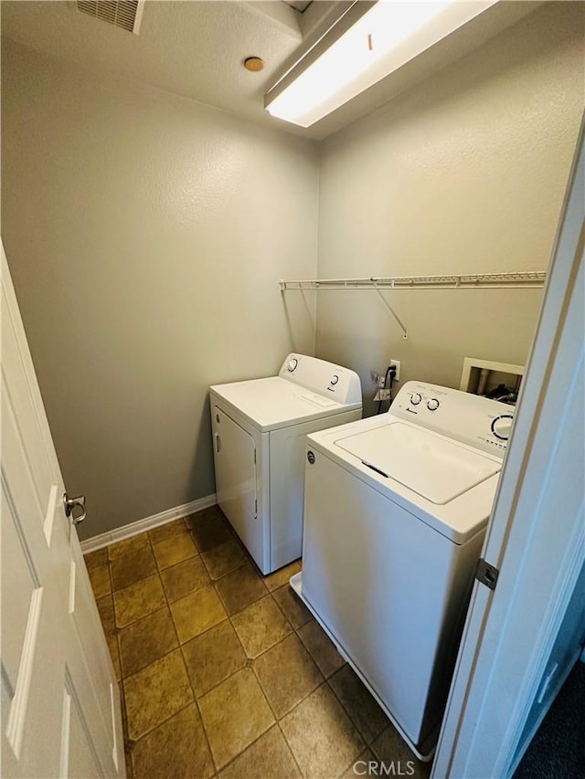 clothes washing area with separate washer and dryer