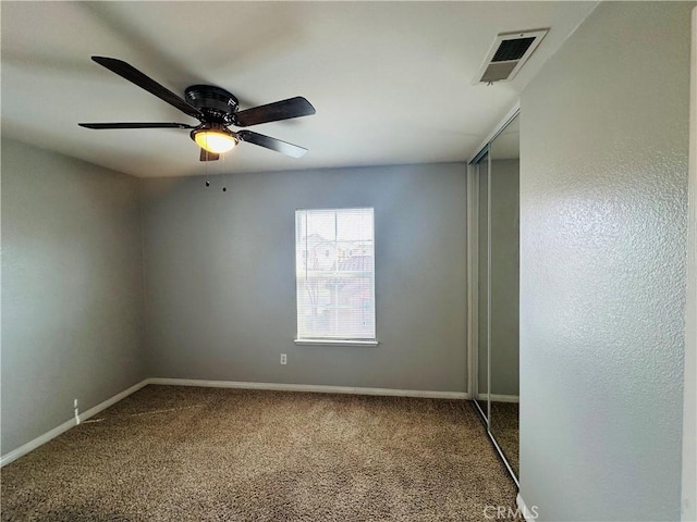 spare room featuring carpet floors and ceiling fan