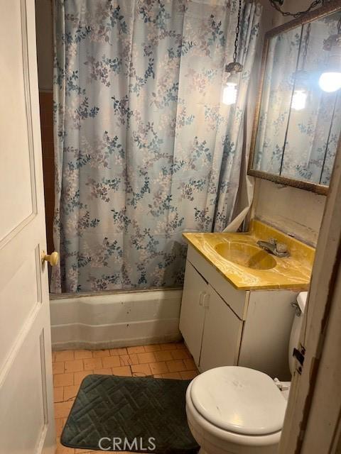 full bathroom featuring shower / tub combo, tile patterned flooring, vanity, and toilet