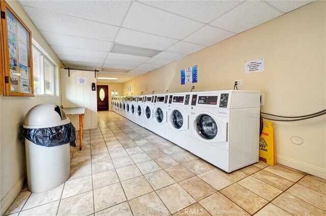 396 S Miraleste Dr Unit 512, San Pedro, CA 90732 - community laundry room featuring washing machine and dryer, baseboards, and light tile patterned floors