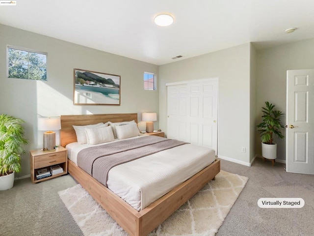 carpeted bedroom featuring a closet