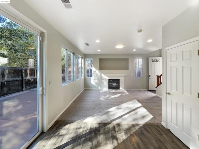 unfurnished living room featuring dark hardwood / wood-style flooring