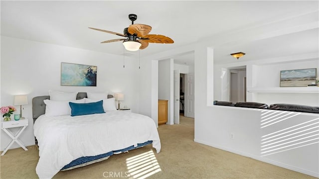 bedroom with a ceiling fan, baseboards, and light carpet