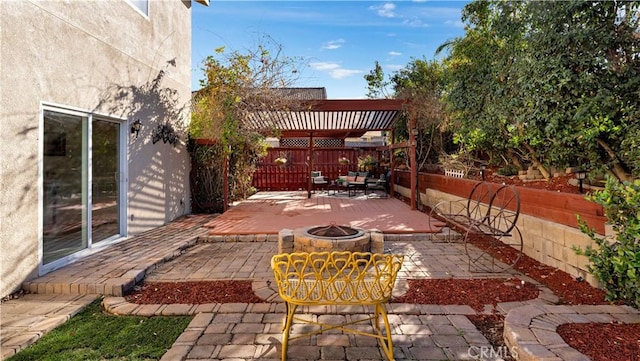 view of patio with a fire pit and fence