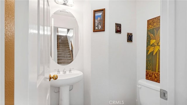 half bathroom with a sink and toilet