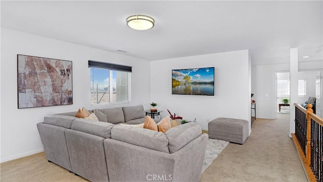 living room with baseboards and light carpet
