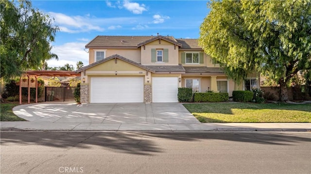 view of front of home featuring concrete driveway, fence, a front yard, and stucco siding