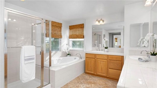 bathroom featuring a bath, vanity, tile patterned floors, and a stall shower