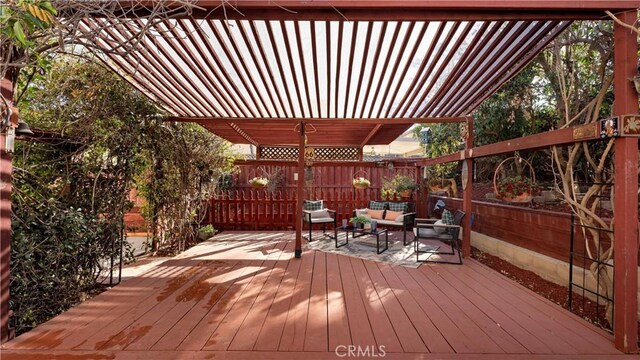 wooden terrace with outdoor lounge area and a pergola