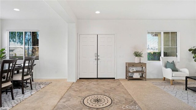 view of carpeted foyer