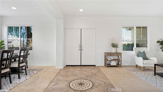 entryway with recessed lighting and light tile patterned floors