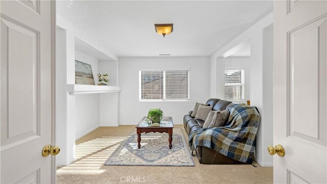 living area with light carpet