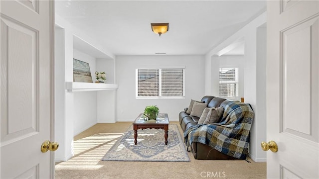 sitting room with baseboards and carpet floors