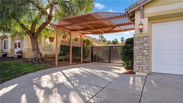 view of patio with driveway and a gate