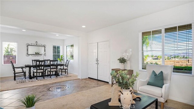 living room featuring light tile patterned flooring and a healthy amount of sunlight