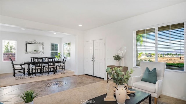 interior space with recessed lighting, a wealth of natural light, tile patterned floors, and baseboards