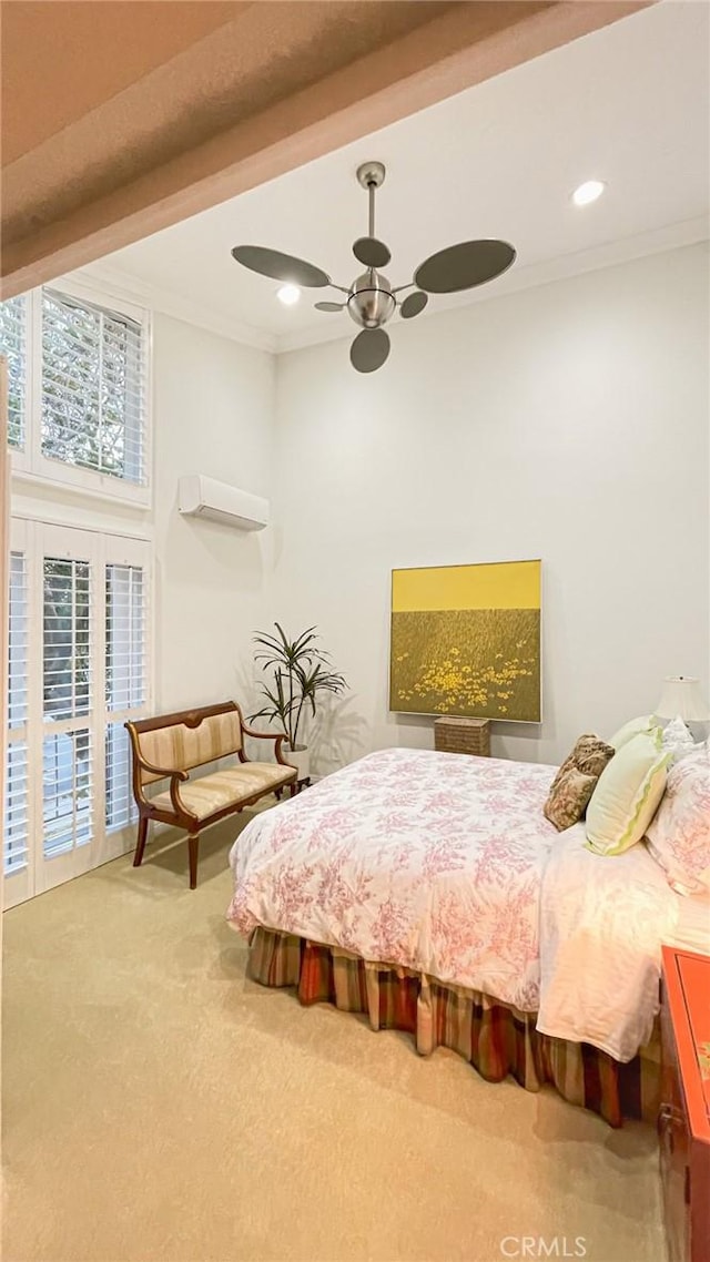 carpeted bedroom featuring ceiling fan, ornamental molding, and a wall unit AC