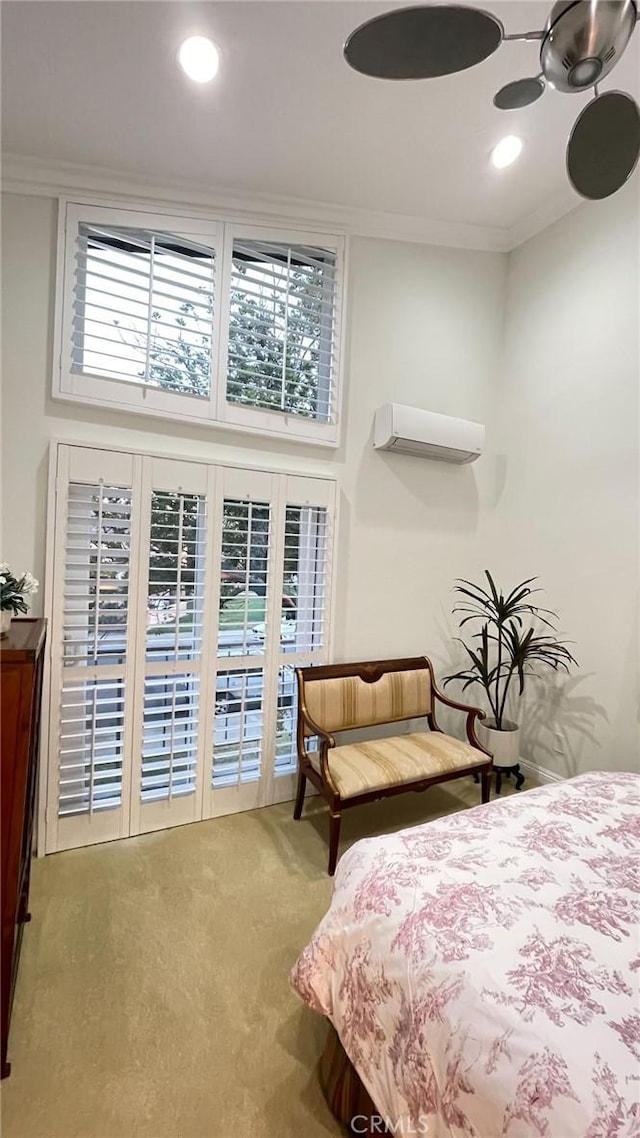 carpeted bedroom featuring an AC wall unit, ceiling fan, and crown molding