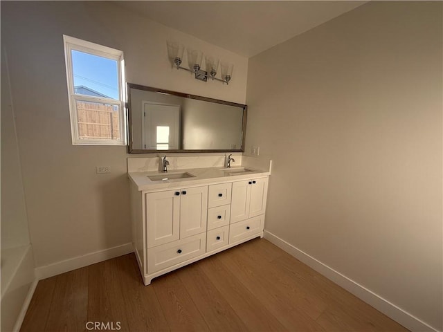 bathroom with vanity and hardwood / wood-style flooring