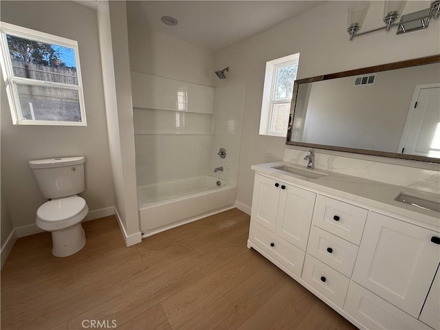 full bathroom with vanity, shower / bathtub combination, toilet, and wood-type flooring