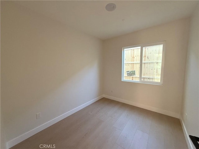 unfurnished room with light hardwood / wood-style flooring