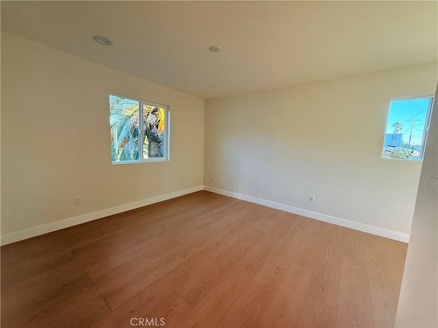 empty room with hardwood / wood-style flooring