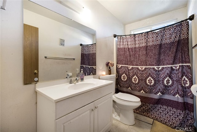 bathroom featuring tile patterned floors, curtained shower, vanity, and toilet