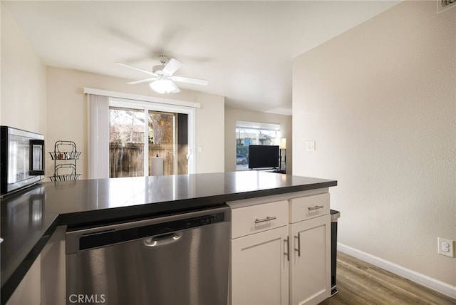 kitchen with ceiling fan, hardwood / wood-style floors, white cabinets, and appliances with stainless steel finishes